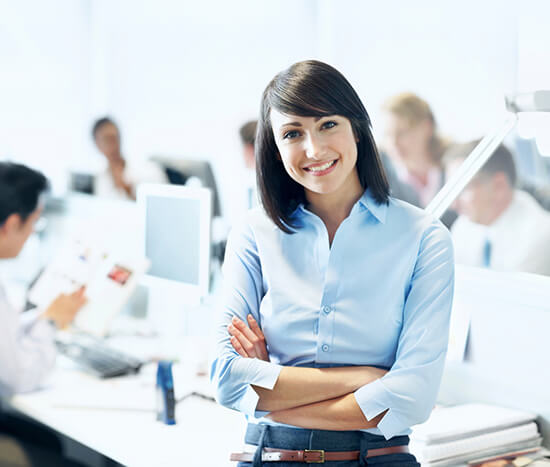 Tax professional standing in a busy accounting office