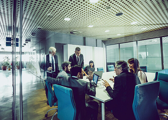 Company directors meeting in a boardroom to review corporate tax matters