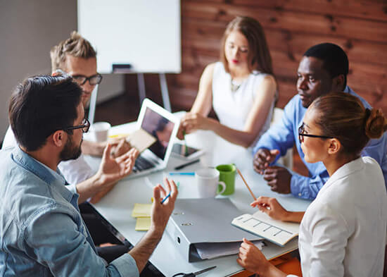 Accounting team coordinating an annual audit around a meeting table