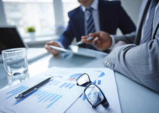 Tax adviser reviewing income tax working papers with a client